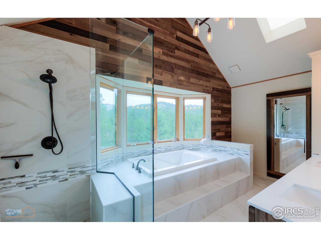 111 Puma Drive Boulder, CO 80302 - Photo 6 of 37 a room with a bed and a chandelier