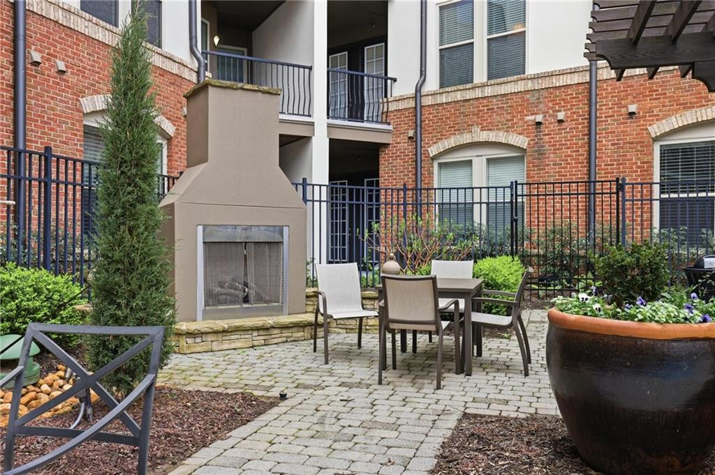 901 Abernathy Road Northeast, Unit 3080 Atlanta, GA 30328 - Photo 17 of 21 a view of a patio with couple of chairs and a fountain