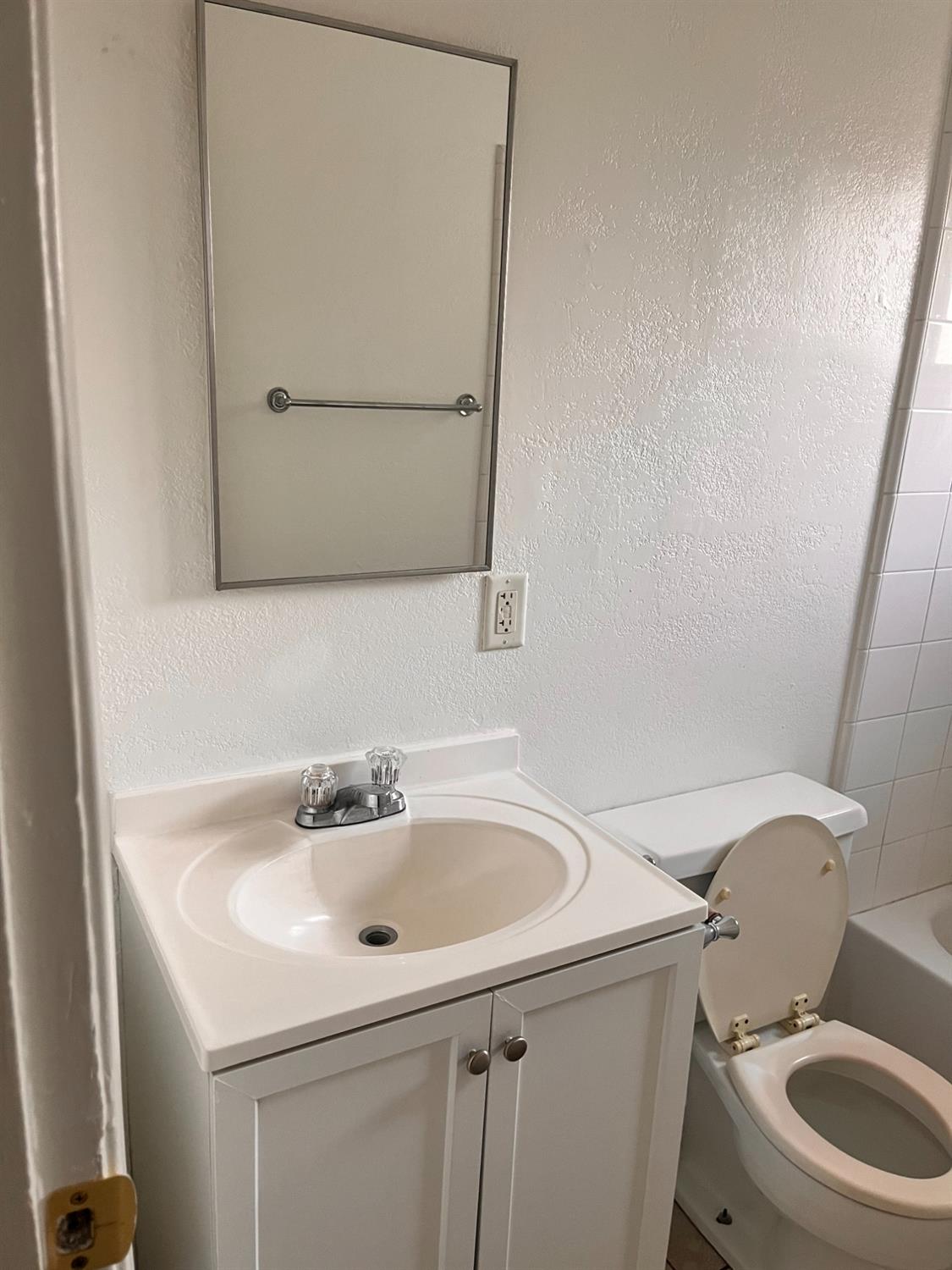 1097 Jefferson Avenue Clovis, CA 93612 - Photo 8 of 11 a bathroom with a sink and a toilet