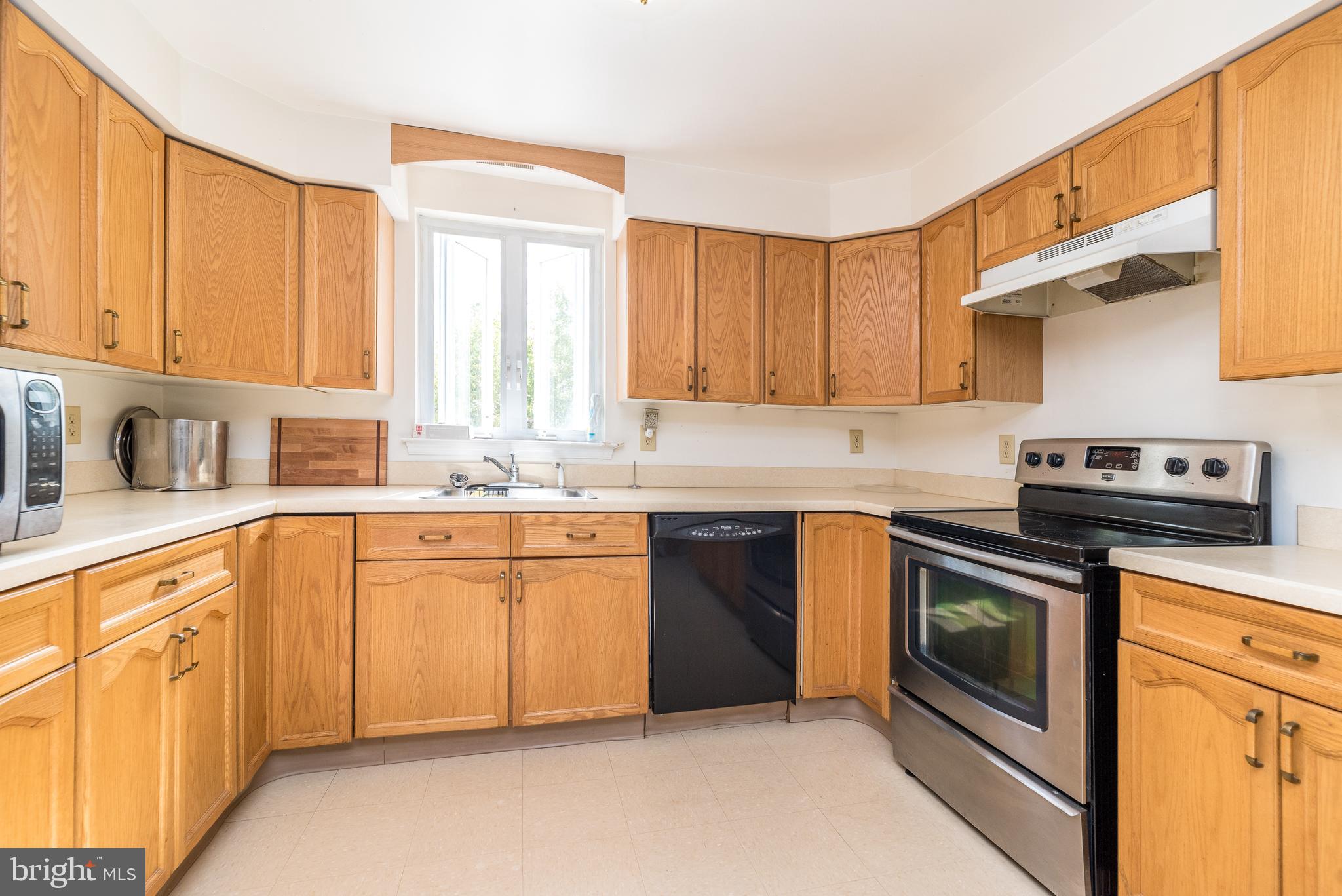 205 South 7th Street Perkasie, PA 18944 - Photo 15 of 24 a kitchen with stainless steel appliances granite countertop a stove a sink and a refrigerator