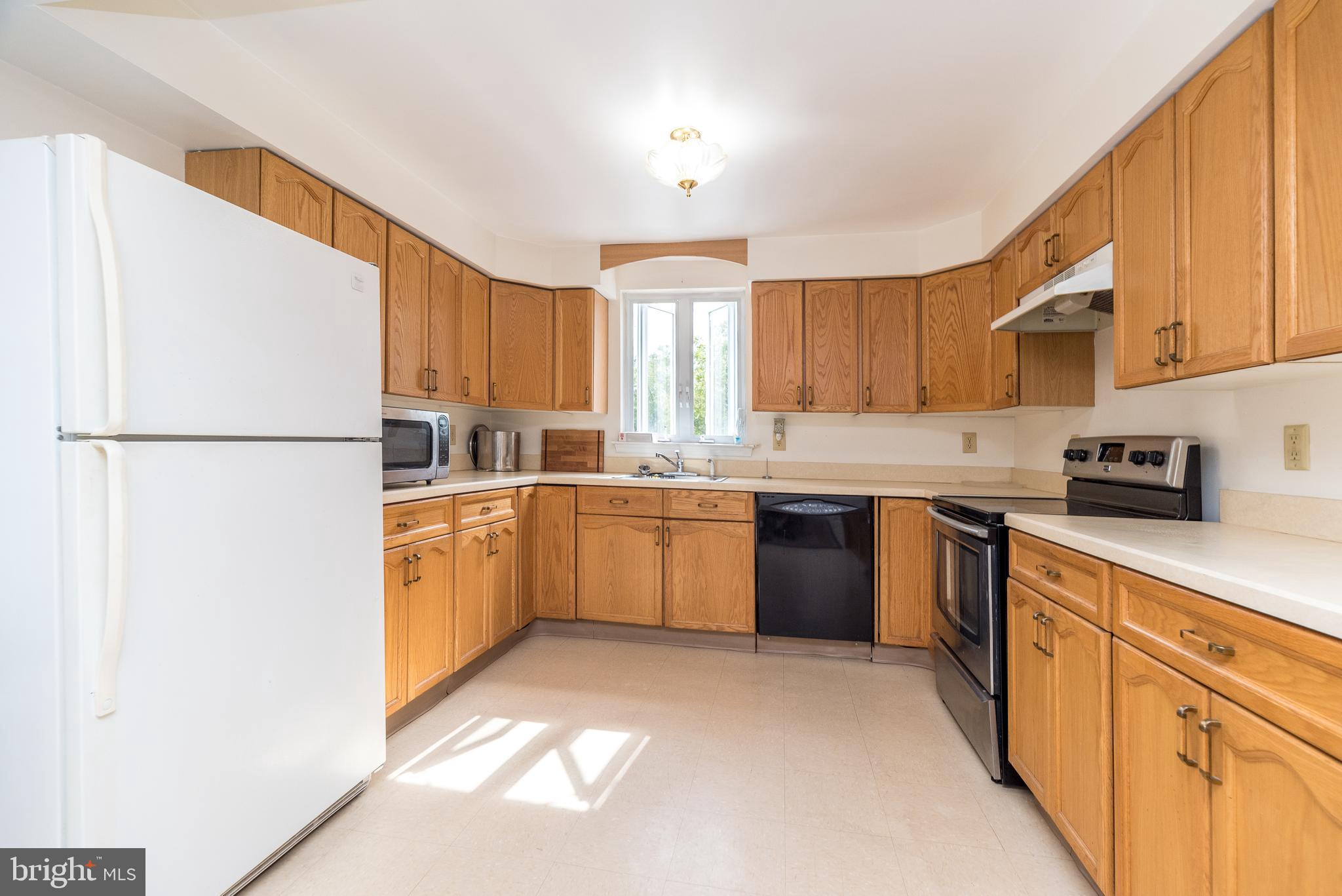 205 South 7th Street Perkasie, PA 18944 - Photo 4 of 24 a kitchen with a sink a refrigerator and cabinets