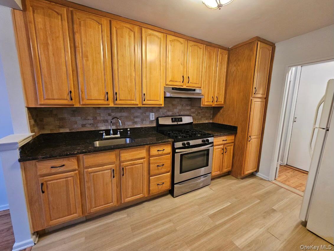 151-05 Cross Island Parkway, Unit 3E Queens, NY 11357 - Photo 1 of 29 a kitchen with stainless steel appliances granite countertop a stove a sink and a refrigerator