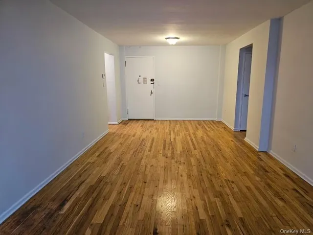 a view of a room with wooden floor