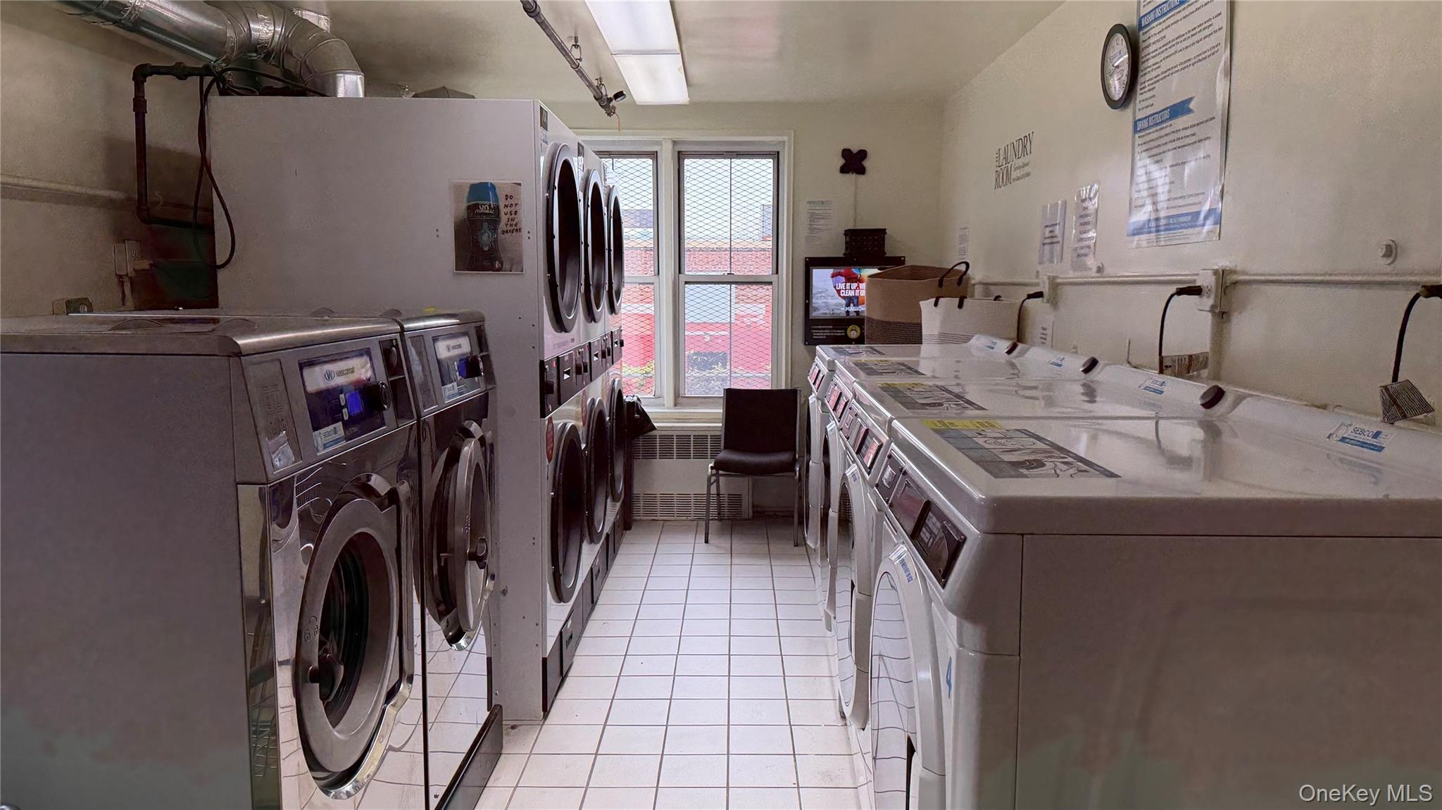 151-05 Cross Island Parkway, Unit 3E Queens, NY 11357 - Photo 18 of 29 a utility room with dryer and washer