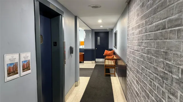 a hallway with furniture and wooden floor