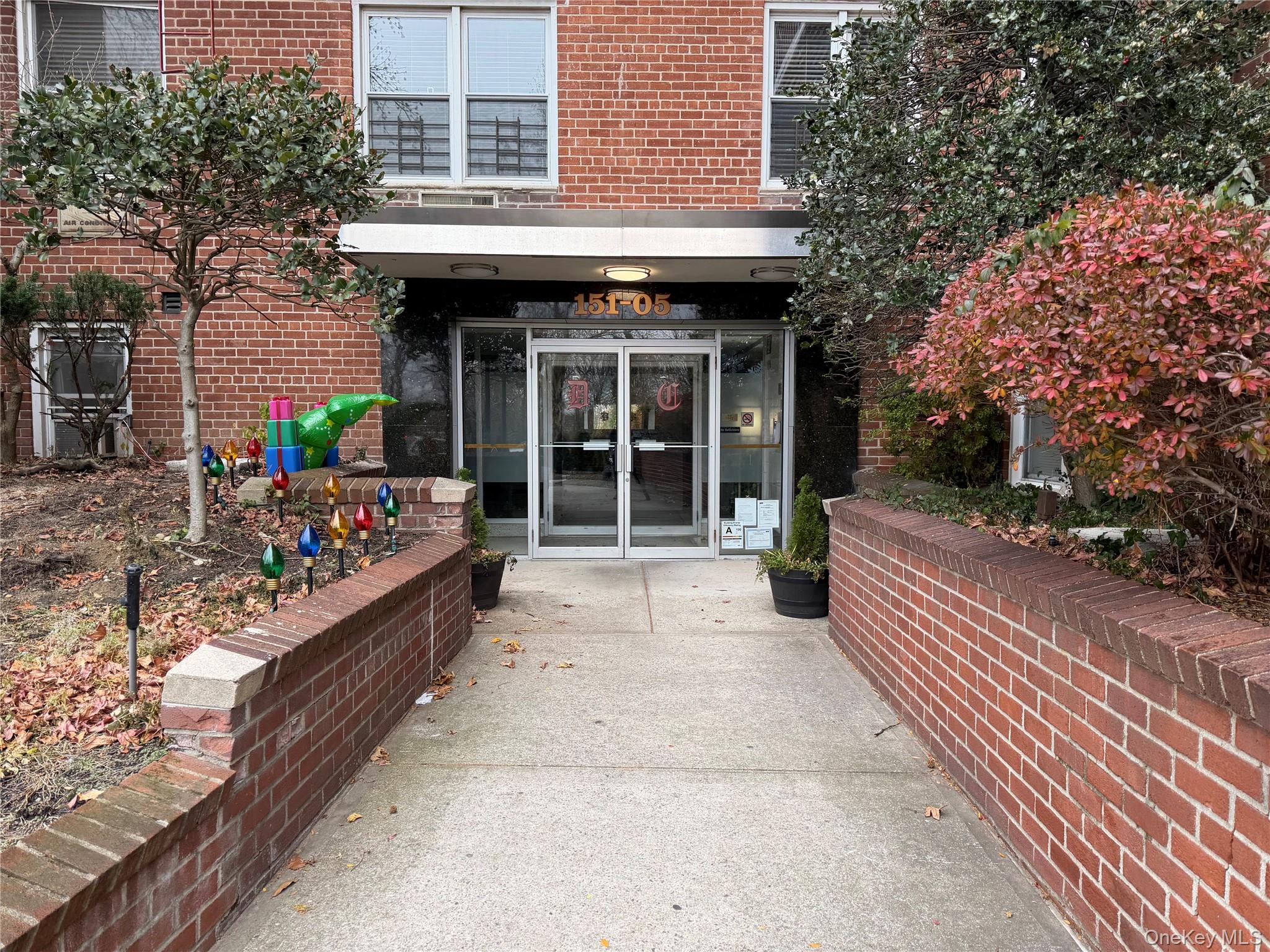 151-05 Cross Island Parkway, Unit 3E Queens, NY 11357 - Photo 27 of 29 a front view of a building with a garden