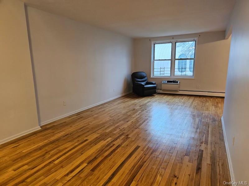 151-05 Cross Island Parkway, Unit 3E Queens, NY 11357 - Photo 4 of 29 a view of a livingroom with wooden floor and window