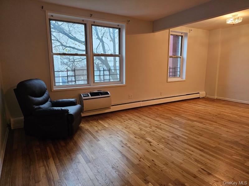 151-05 Cross Island Parkway, Unit 3E Queens, NY 11357 - Photo 5 of 29 a living room with furniture and wooden floor