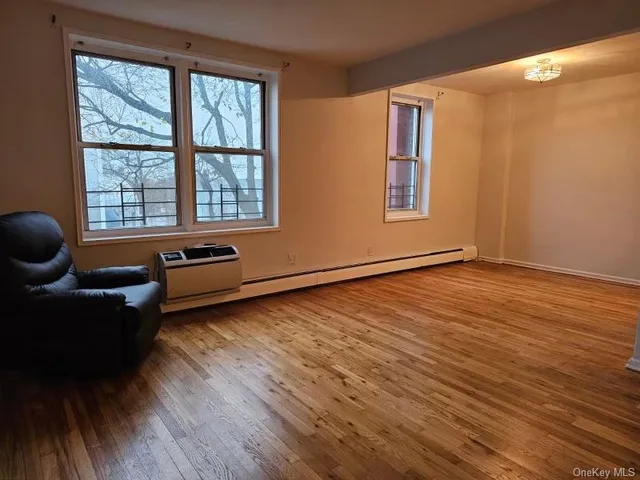 a living room with furniture and a hard wood floor