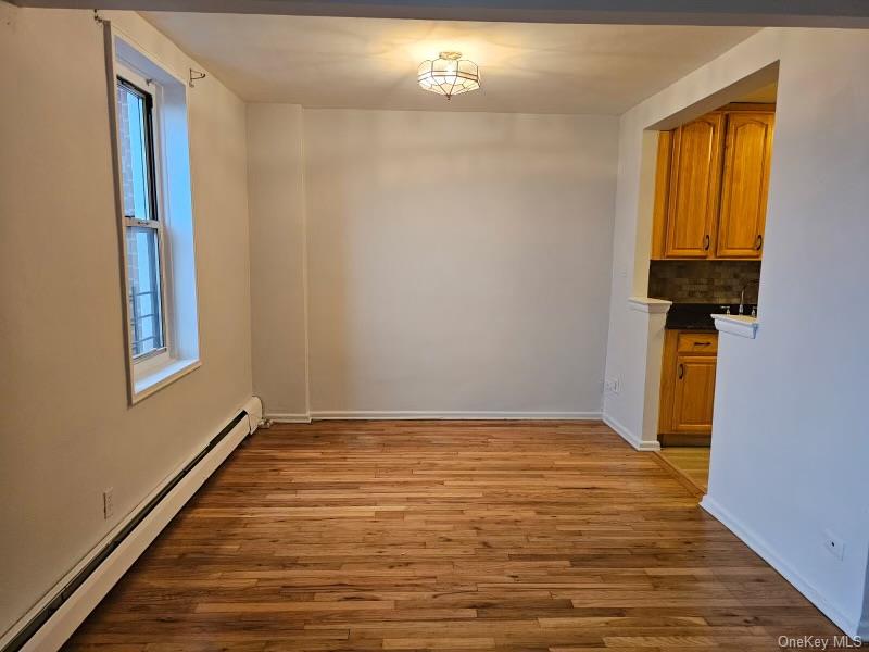 151-05 Cross Island Parkway, Unit 3E Queens, NY 11357 - Photo 10 of 29 a view of an empty room with window and wooden floor
