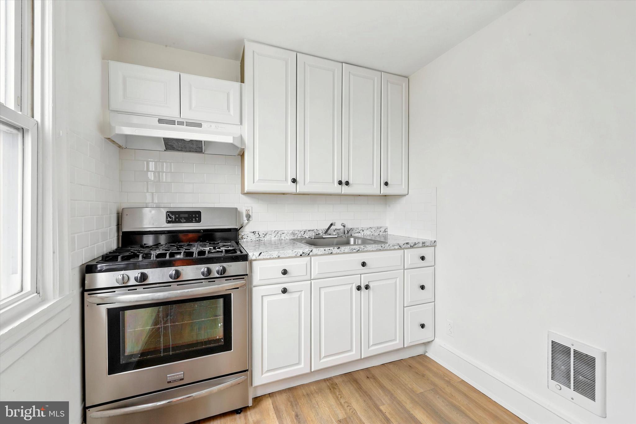 55 Richfield Road Upper Darby, PA 19082 - Photo 21 of 33 a kitchen with granite countertop white cabinets and stainless steel appliances