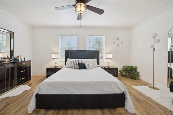 a bedroom with a bed and a chandelier