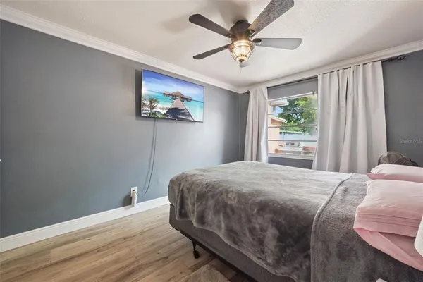 a bedroom with a large bed and a window