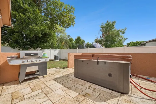 a view of a house with a yard and sitting area