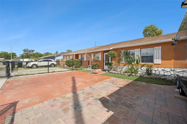 a view of a house with backyard porch and sitting area