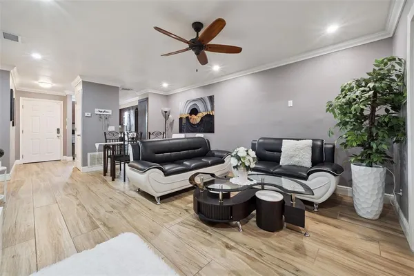 a living room with furniture or couch and a potted plant