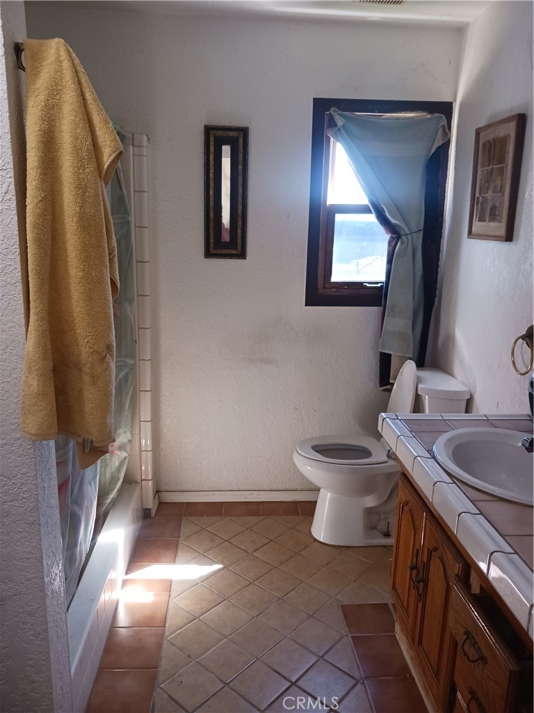 477 County Line Road Calimesa, CA 92320 - Photo 9 of 19 a bathroom with a toilet sink and mirror