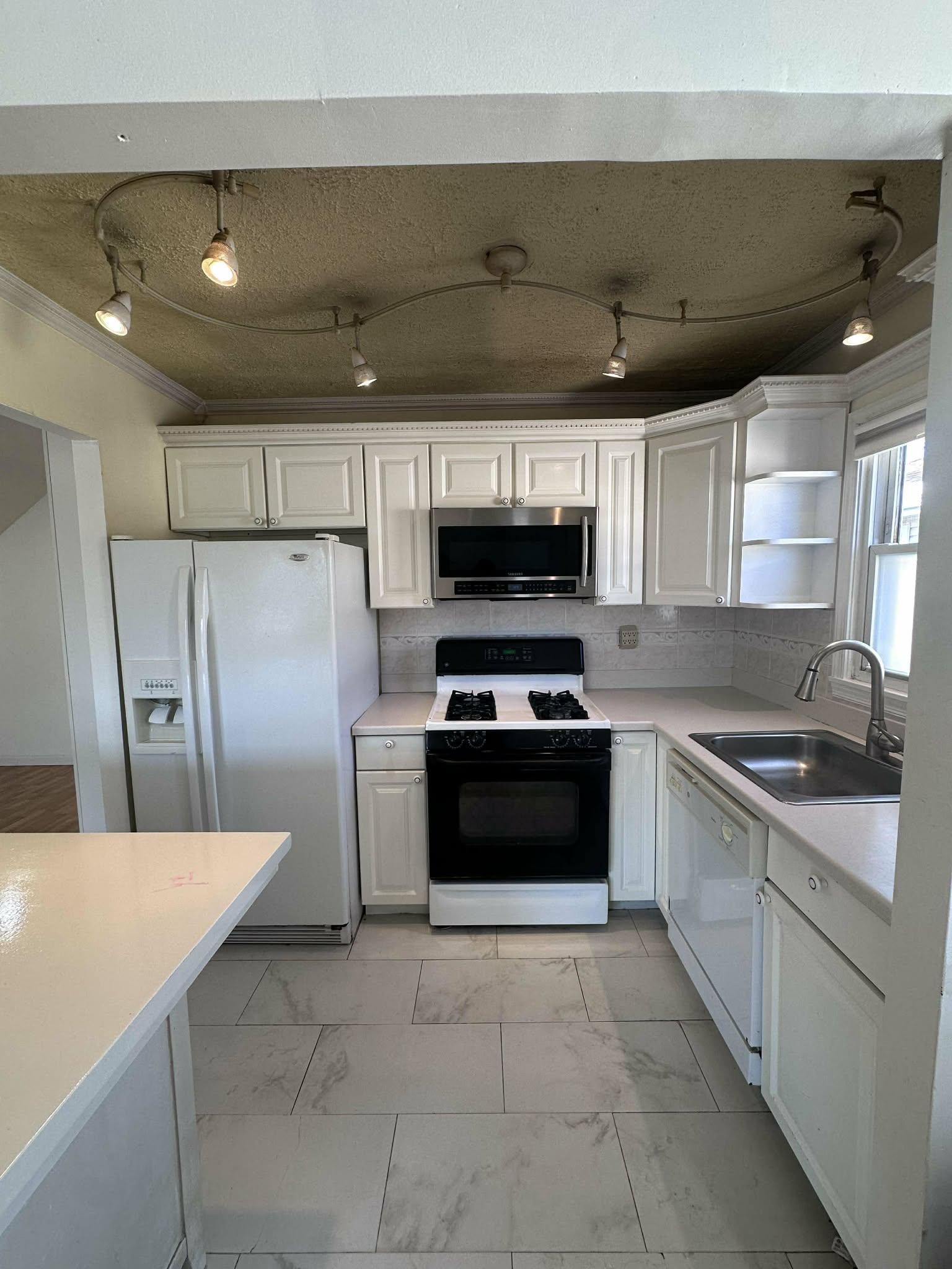 67 Country Village Road, Unit 2 Jersey City, NJ 07305 - Photo 12 of 20 a kitchen with stainless steel appliances granite countertop a refrigerator and a stove top oven