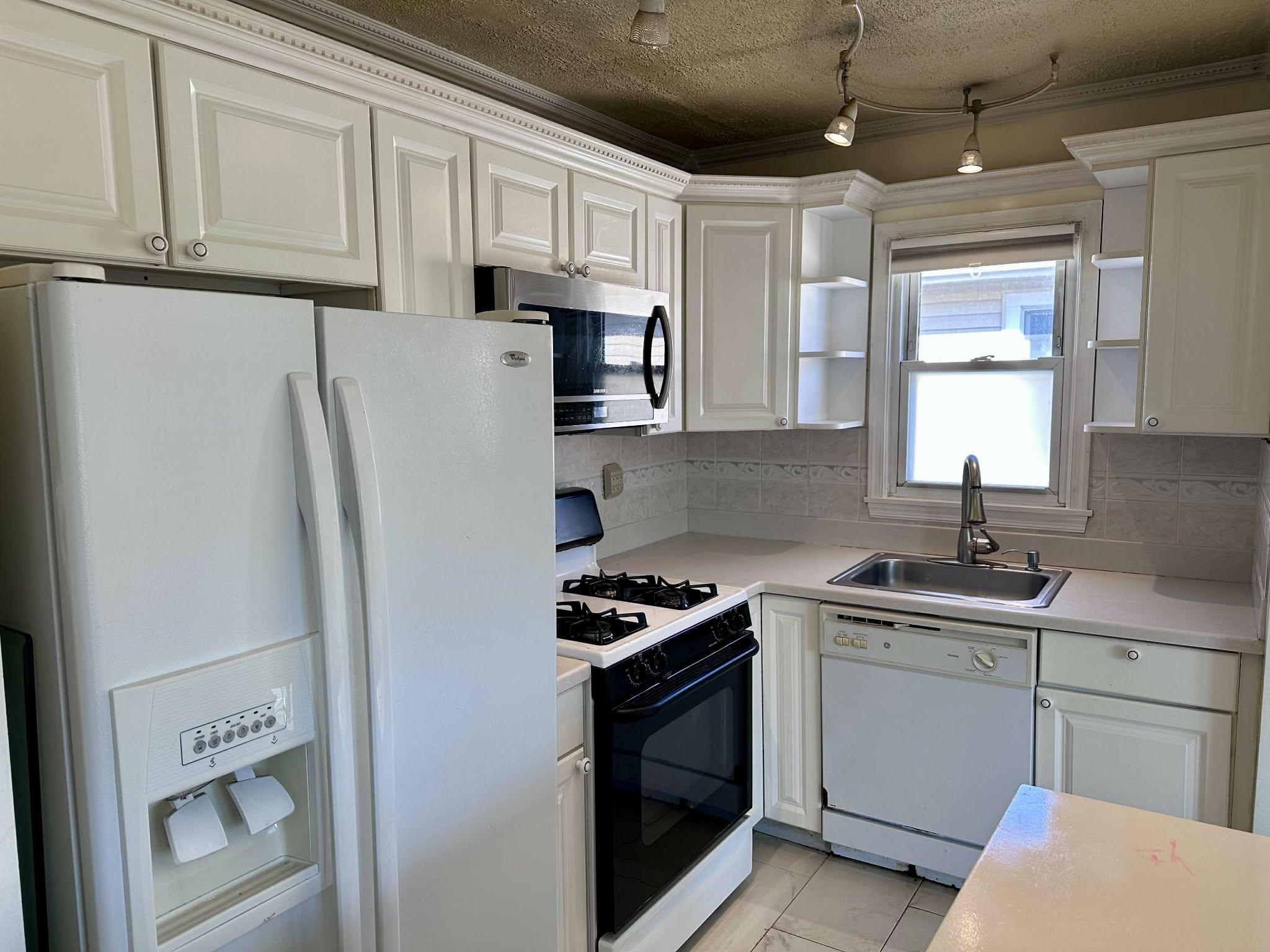 67 Country Village Road, Unit 2 Jersey City, NJ 07305 - Photo 13 of 20 a kitchen with stainless steel appliances granite countertop a refrigerator sink and stove