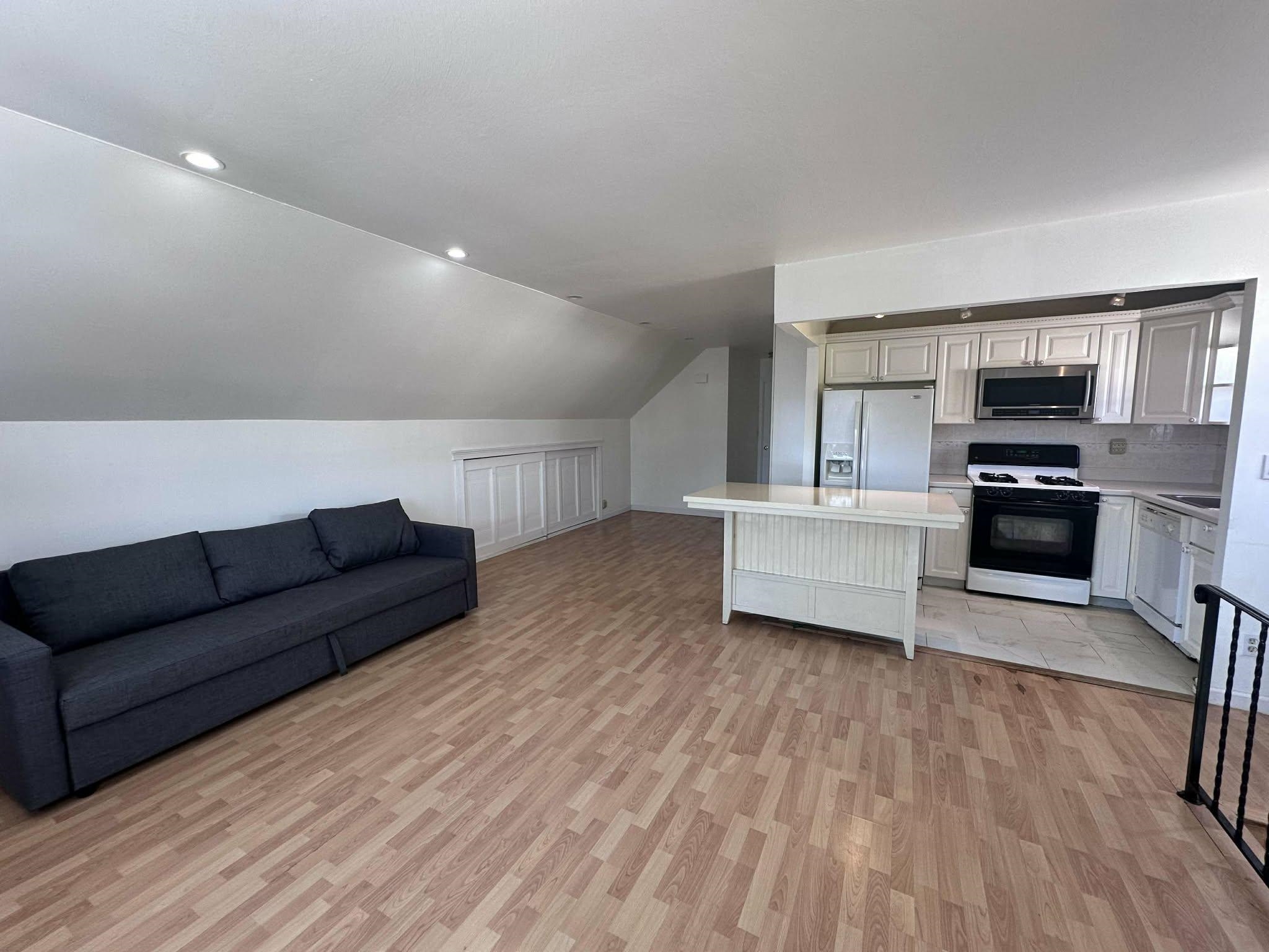 67 Country Village Road, Unit 2 Jersey City, NJ 07305 - Photo 14 of 20 a living room with furniture and a wooden floor