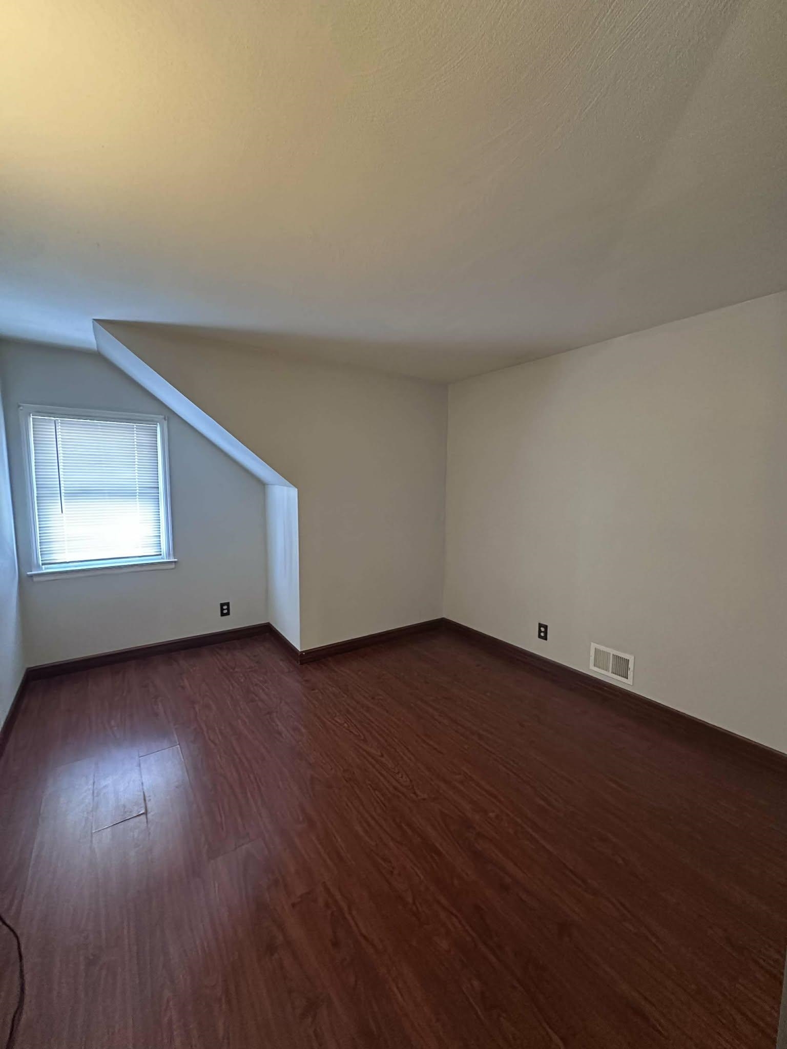 67 Country Village Road, Unit 2 Jersey City, NJ 07305 - Photo 15 of 20 an empty room with wooden floor and windows