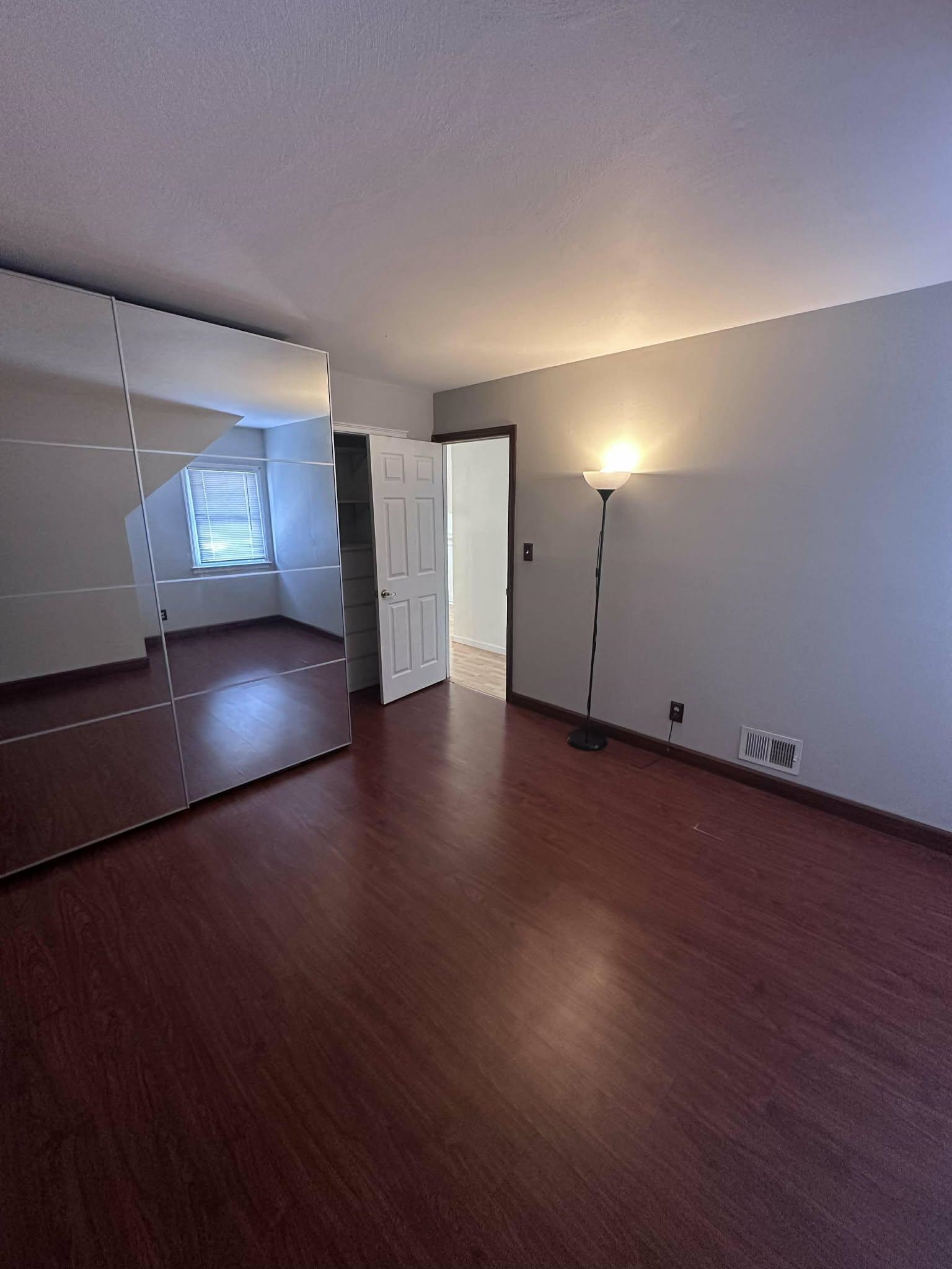 67 Country Village Road, Unit 2 Jersey City, NJ 07305 - Photo 20 of 20 an empty room with wooden floor and windows