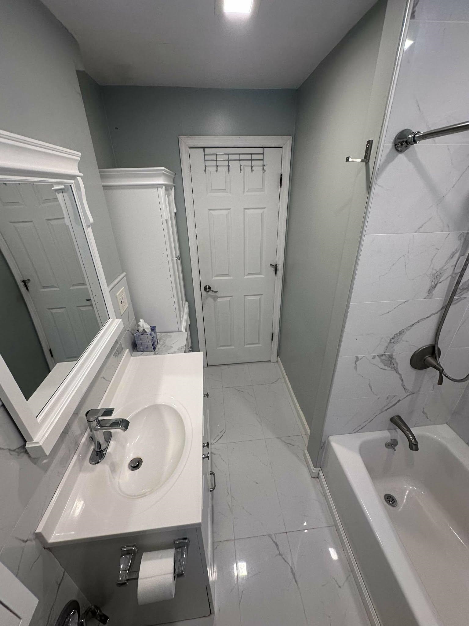 67 Country Village Road, Unit 2 Jersey City, NJ 07305 - Photo 8 of 20 a bathroom with a sink a toilet and shower