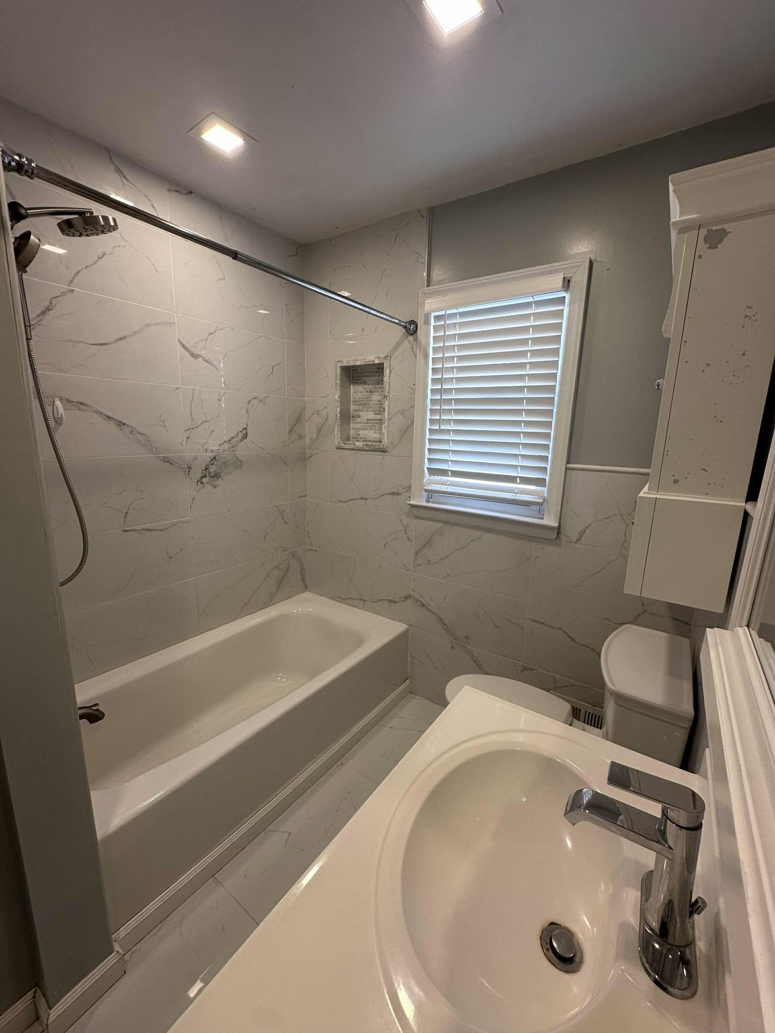 67 Country Village Road, Unit 2 Jersey City, NJ 07305 - Photo 9 of 20 a bathroom with a sink a toilet and shower