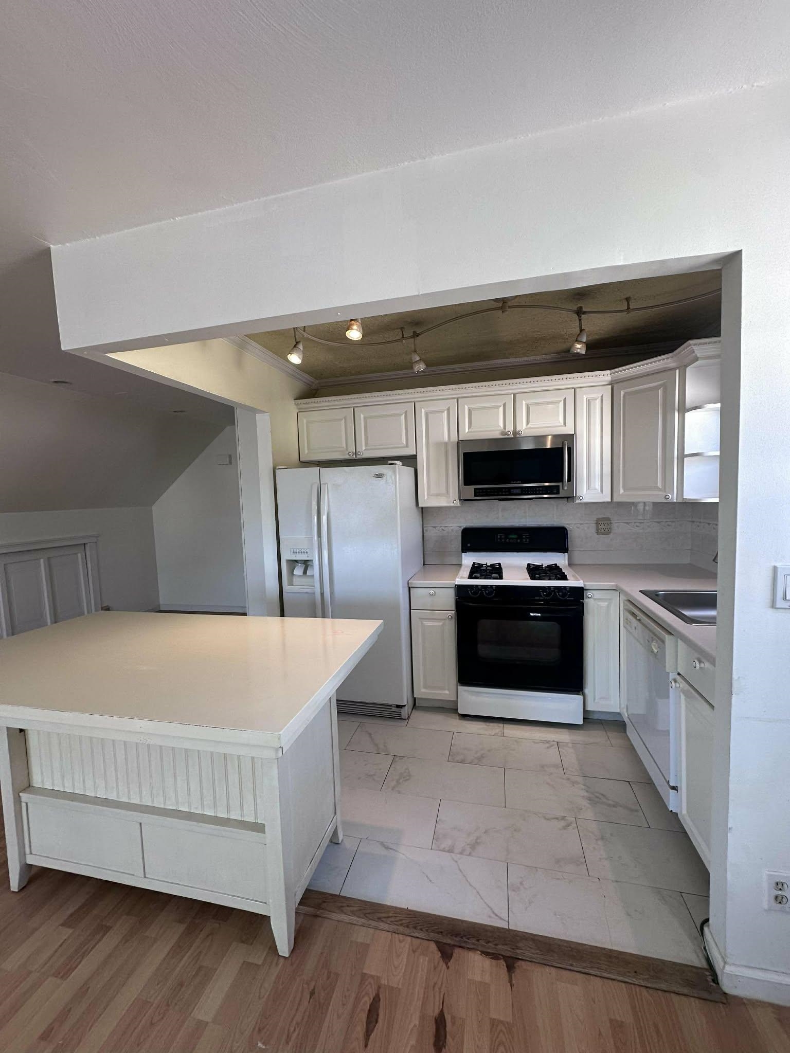 67 Country Village Road, Unit 2 Jersey City, NJ 07305 - Photo 10 of 20 a kitchen with stainless steel appliances a refrigerator and a stove top oven
