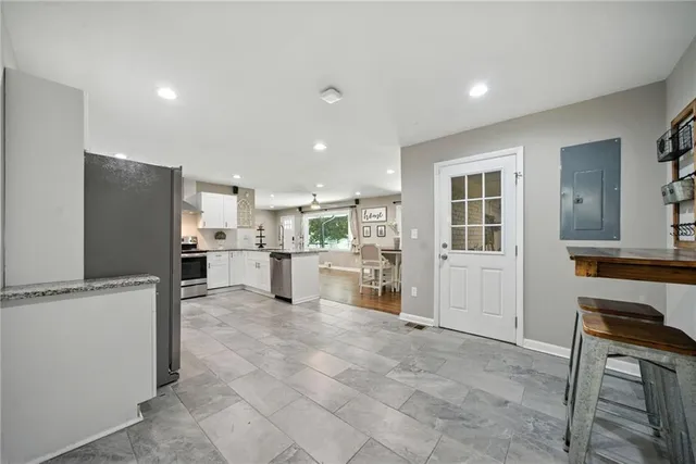 a view of kitchen with furniture and refrigerator