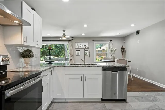 a kitchen with granite countertop a sink and cabinets