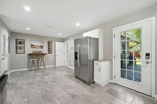 a view of a big room with large windows and cabinet