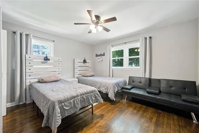 a bedroom with two beds and a large window