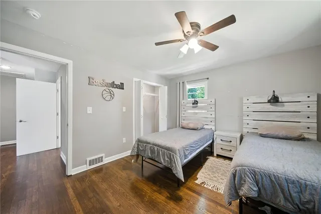 a bedroom with bed and wooden floor