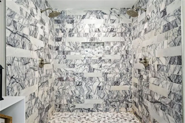 a bathroom with a bathtub and shower