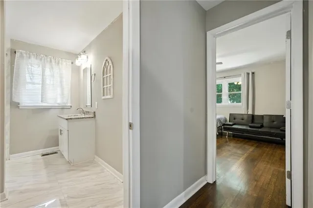a view of a bedroom with wooden floor and a window