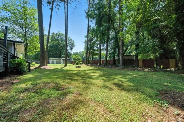 a view of a backyard with a garden and entertaining space