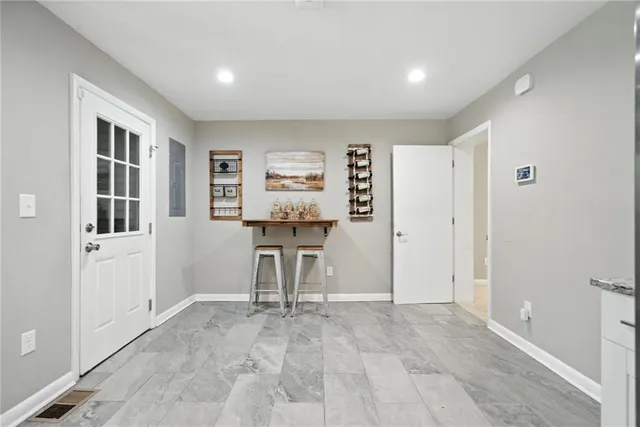 a view of a room with gym equipment and windows