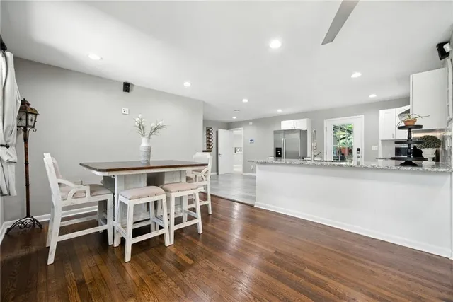 a view of a dining room with furniture and wooden floor
