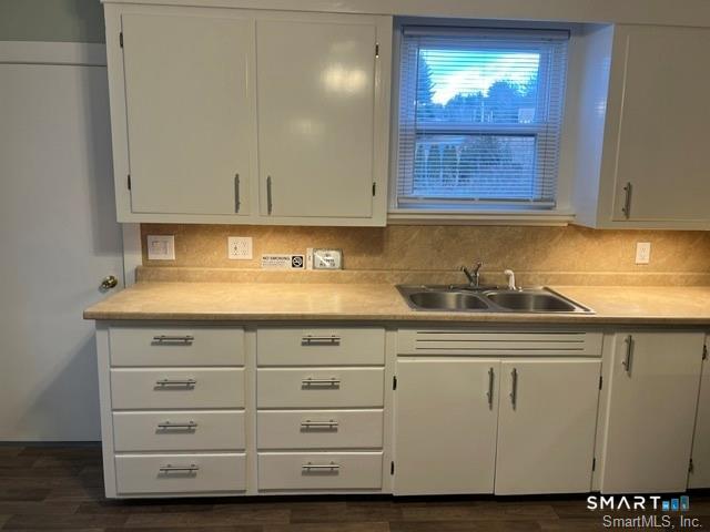 6 Boys Avenue Killingly, CT 06263 - Photo 8 of 20 a view of cabinets a sink and a stove with wooden floor