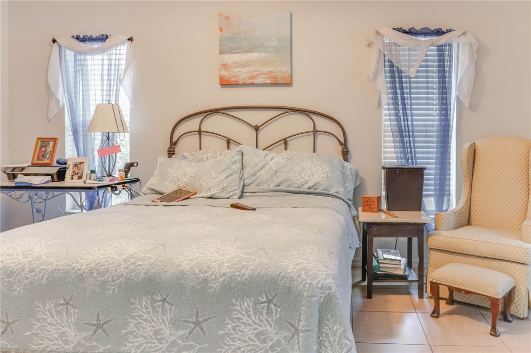 243 Main Street Sebastian, FL 32958 - Photo 11 of 11 a bedroom with bed and a chair with window