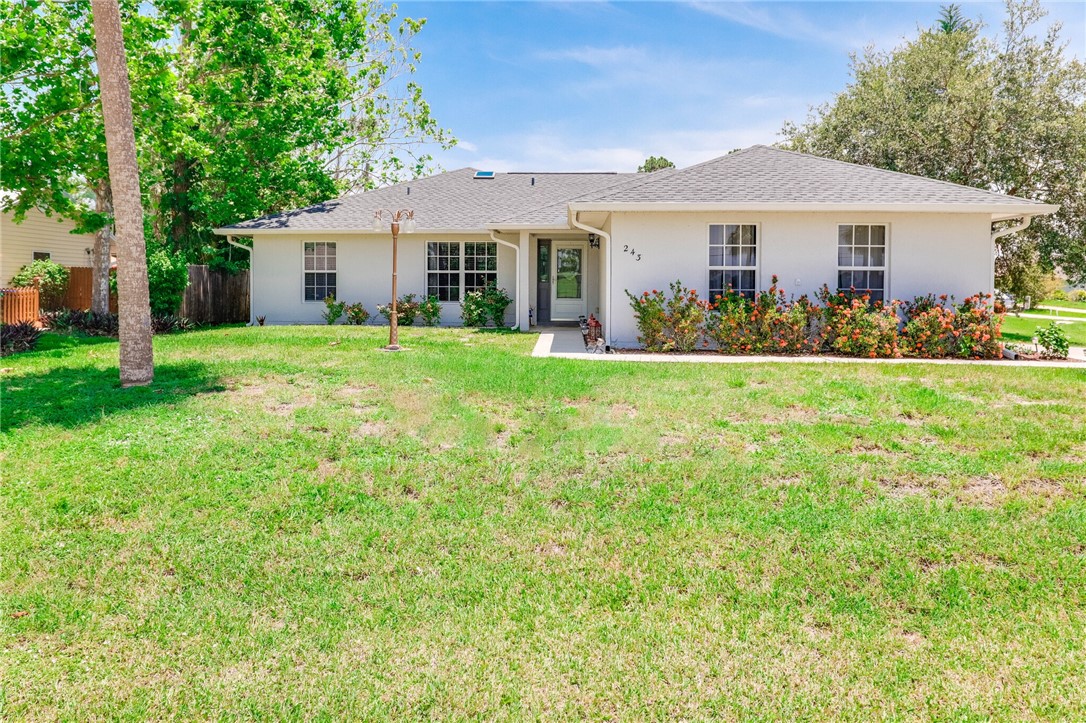 243 Main Street Sebastian, FL 32958 - Photo 2 of 11 a front view of a house with a garden