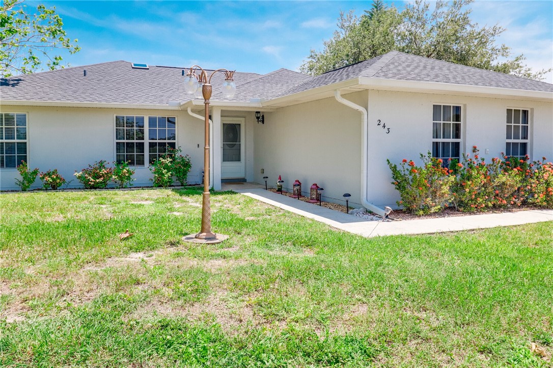 243 Main Street Sebastian, FL 32958 - Photo 3 of 11 a view of a house with backyard and garden