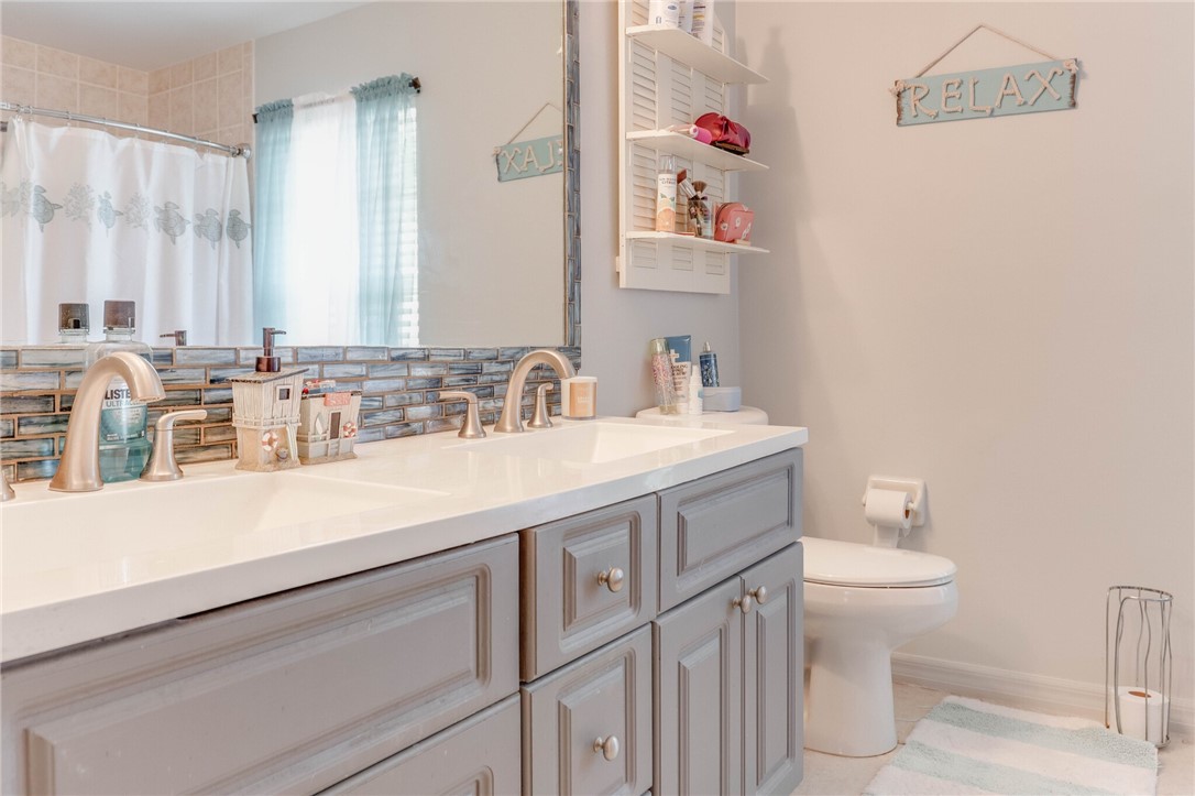 243 Main Street Sebastian, FL 32958 - Photo 6 of 11 a bathroom with a sink and a toilet