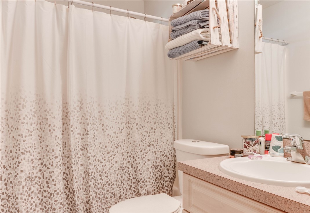 243 Main Street Sebastian, FL 32958 - Photo 9 of 11 a bathroom with a sink a toilet and shower curtain