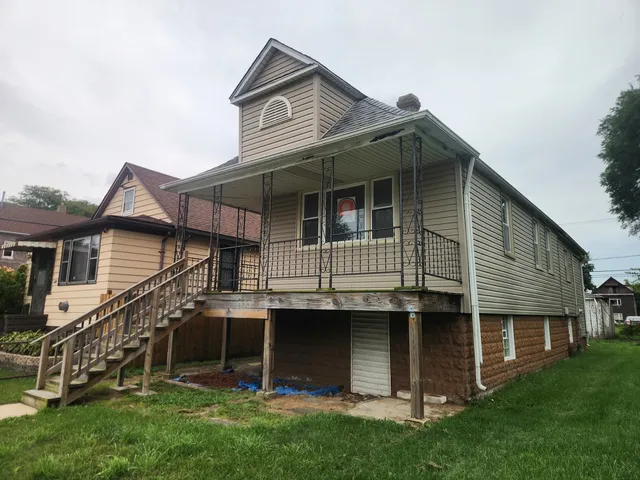 a front view of a house with a garden and plants