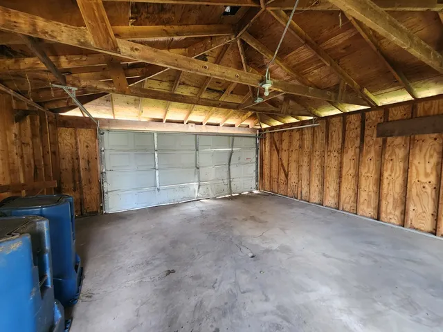 a view of empty room with wooden walls