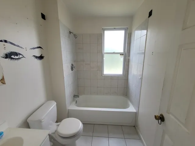 a bathroom with a toilet bathtub and shower