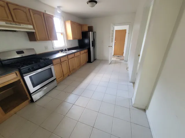 a kitchen with stainless steel appliances granite countertop a sink stove and cabinets