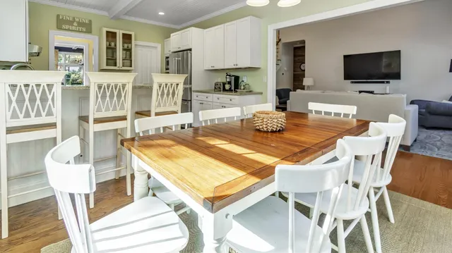a view of a dining room with furniture and a flat screen tv